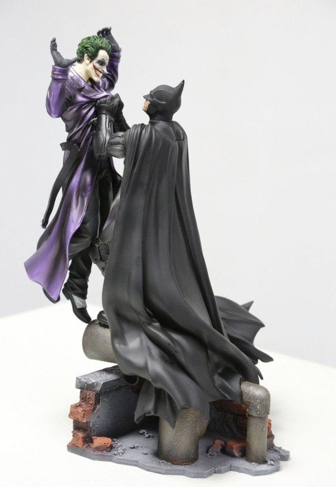 Batman holding the Joker Batman: Arkham Origins Collector’s Edition