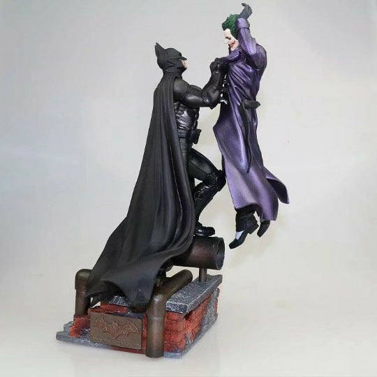 Batman holding the Joker Batman: Arkham Origins Collector’s Edition