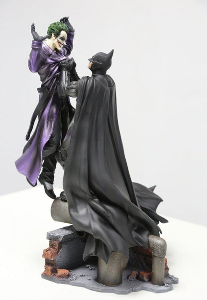 Batman holding the Joker Batman: Arkham Origins Collector’s Edition
